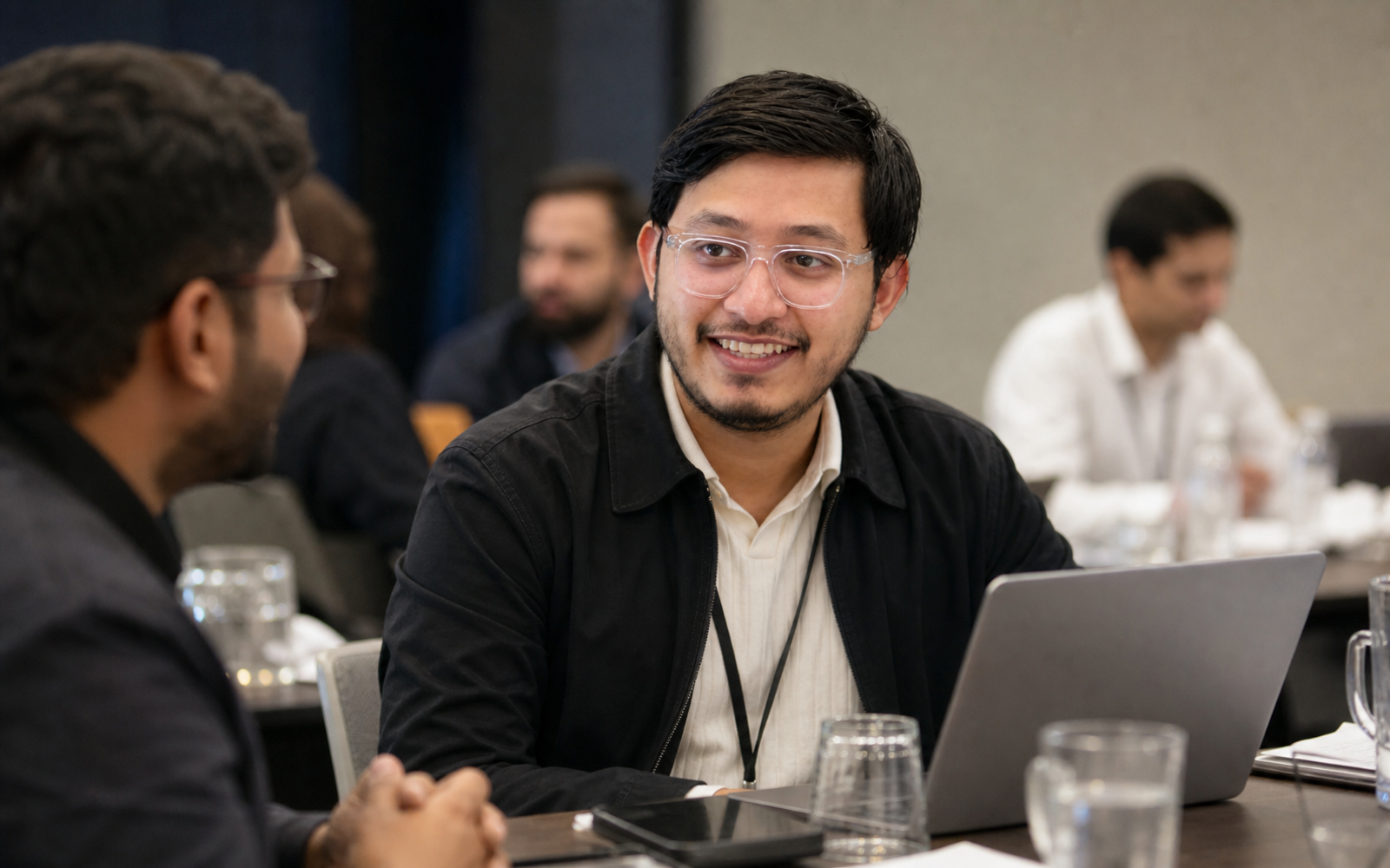 Sanket speaking with attendees at a business event